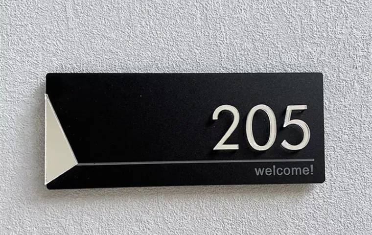 Installed black room number sign 205